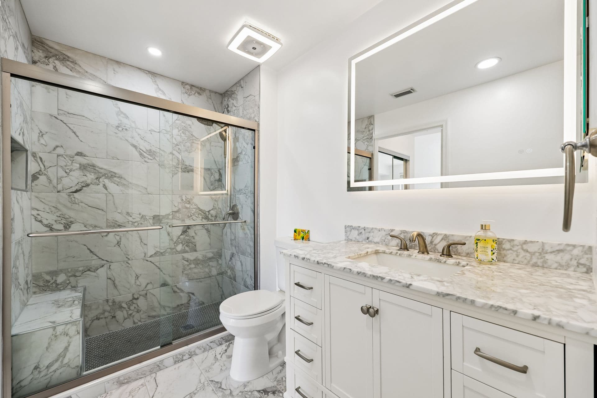 Shower floor detail with penny tile and marble walls